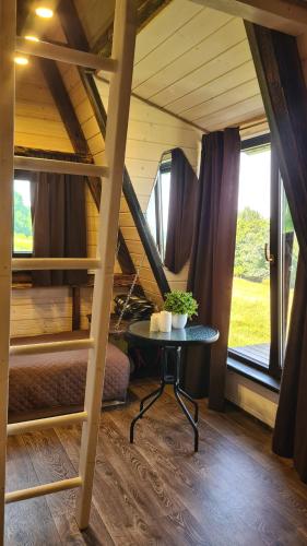 a room with two bunk beds and a table at Горный приют in Yabluniv