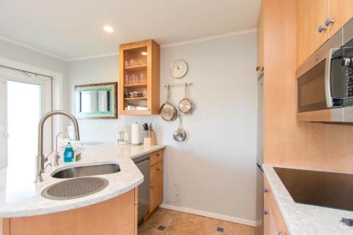 a kitchen with a sink and a microwave at The Ocean Dunes at Amagansett in Amagansett