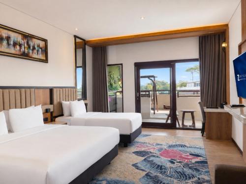 a hotel room with two beds and a television at Zenith Sunshine in Lebakwangi