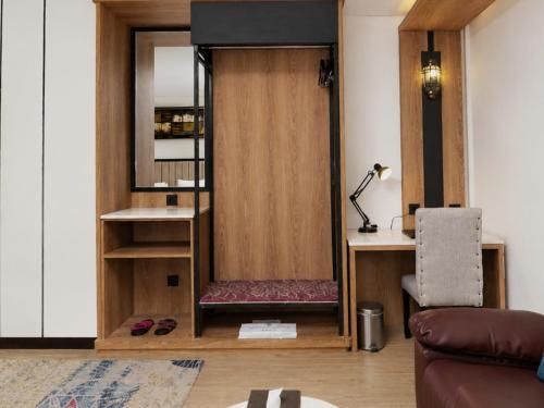 a living room with a bed and a desk at Zenith Sunshine in Lebakwangi