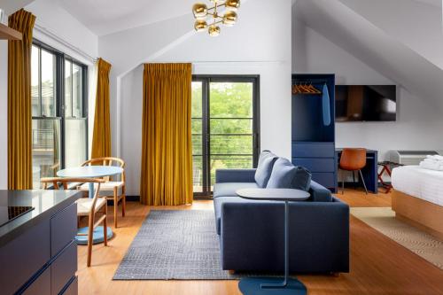 a living room with a blue couch and a table at The Foreside Inn in Kittery