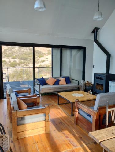 a living room with a couch and a table at Cabaña San Charbel in Potrerillos