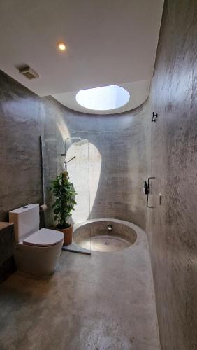 a bathroom with a shower and a toilet and a plant at CASA MAGALI in Sant Francesc Xavier