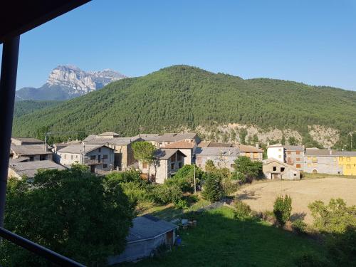 a view of a town with a mountain in the background at APARTAMENTOS Hotel TurMo in Labuerda