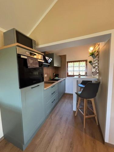 a kitchen with a counter and a chair in it at Naturcamp Duvendiek Blockhäuschen in Niepars