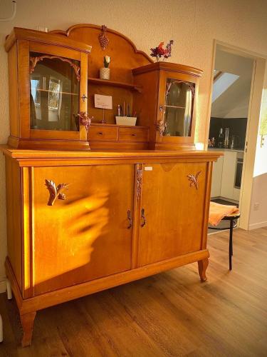 a wooden cabinet with a mirror on top of it at Stilvolles Loft-Apartment in Gais