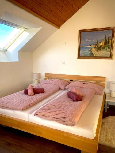 a bedroom with two beds with pink pillows on them at Stilvolles Loft-Apartment in Gais