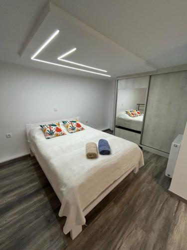 a bedroom with a large bed with two towels on it at Elia Apartments in Eretria