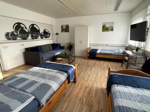 a bedroom with two beds and a tv in it at Stumpf Verpachtung Gbr in Treuchtlingen