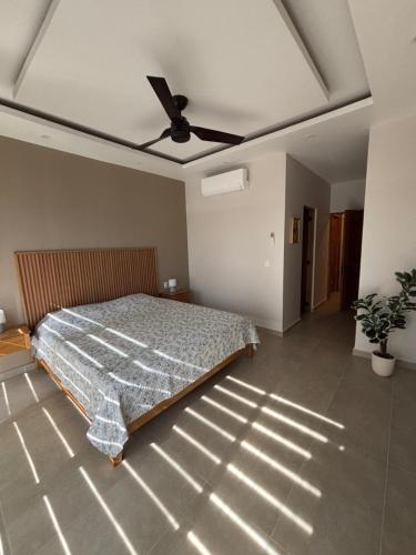 a bedroom with a bed and a ceiling fan at Santa Cruz Condo in Santa Cruz Huatulco