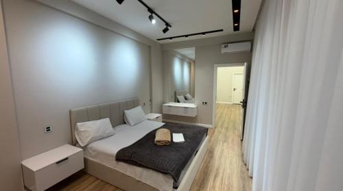 a small bedroom with a bed and a mirror at Modern Villa in Quba City Center in Quba