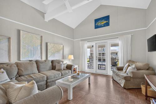 a living room with a couch and a table at The Edistoneyan in Edisto Island