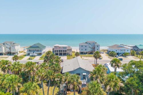 an aerial view of a resort with palm trees and the ocean at The Edistoneyan in Edisto Island