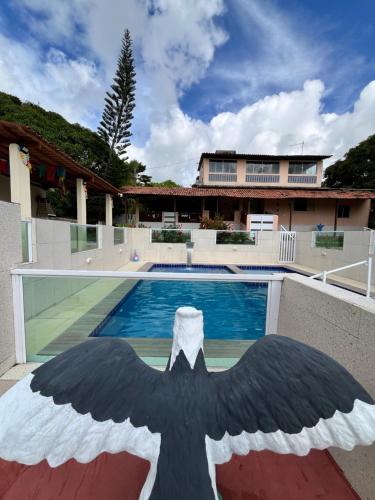 a large butterfly painted on the side of a swimming pool at Villa Velha Flats in Itamaracá