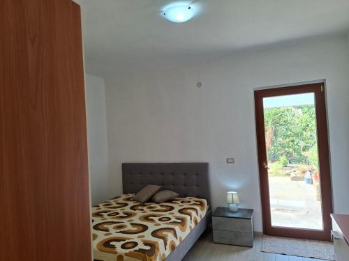 a bedroom with a bed and a door to a yard at Casa mariano in Marconia