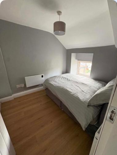 a small bedroom with a bed and a window at The City Walls Residence in Waterford