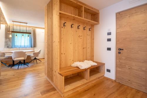 a room with a wooden door and a table at Lüch dl Chessl - Kesslhof in San Martino in Badia