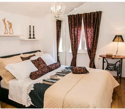 a bedroom with a bed with pillows on it at Garden in Šibenik