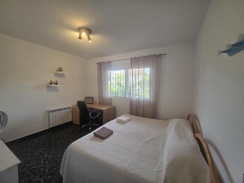 a bedroom with a bed and a desk and a window at Mirador de Bolnuevo in Bolnuevo