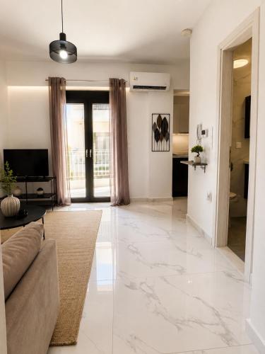 a living room with a couch and a large marble floor at Skyloft Meteora 1 in Kalabaka