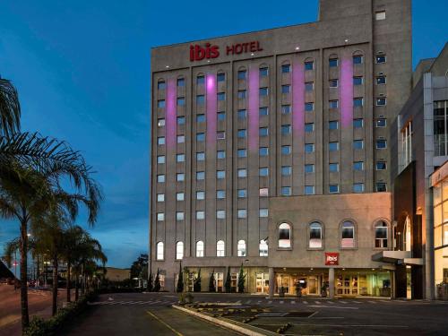 a building with pink lights on the side of it at ibis Sao Paulo Interlagos in São Paulo