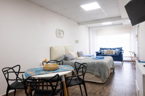 a living room with a bed and a table and chairs at Complejo Vista Tres Picos in Sierra de la Ventana