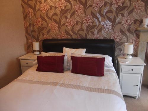 A bed or beds in a room at Warrington Guest House 