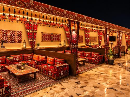 a restaurant with red couches and a table in a room at Crystal pyramid inn in Cairo