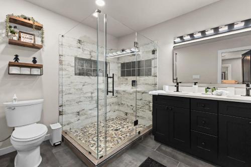 a bathroom with a shower with a toilet and a sink at Boerne Birdie Ranch in Boerne