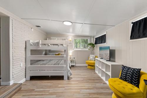 a bedroom with two bunk beds and a yellow chair at Boerne Birdie Ranch in Boerne
