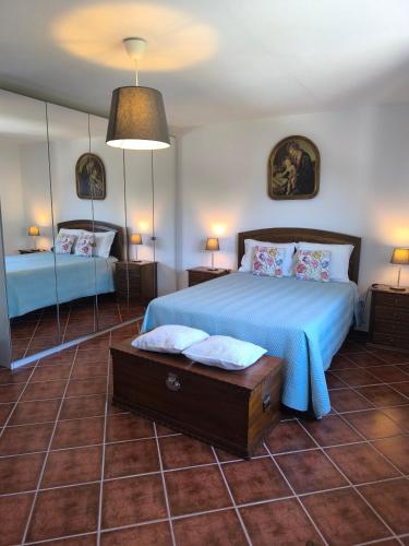 a bedroom with a bed with a blue comforter at Quinta do Retiro in Felgar