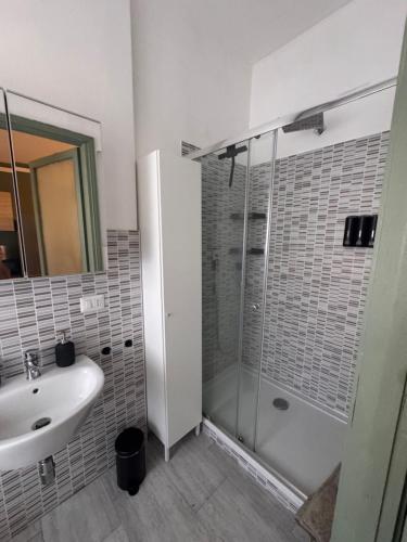 a white bathroom with a sink and a shower at Le due dimore del Baluardo in Novara