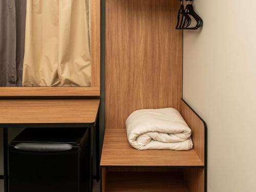 a white towel is sitting on a shelf in a closet at Ibis Joao Pessoa Praia in João Pessoa
