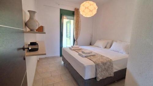 a bedroom with a bed with towels on it at Elthea Villa in Skala Fourkas