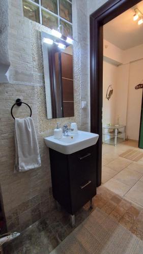a bathroom with a sink and a mirror at Elthea Villa in Skala Fourkas