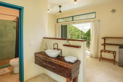 a bathroom with a sink and a toilet at Casa Mia El Cuyo Eco Beach Boutique Hotel Sin Aire Acondicionado in El Cuyo