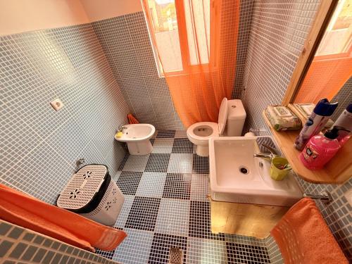 a bathroom with a toilet and a sink at Ocean Pearl Beach House in Morro