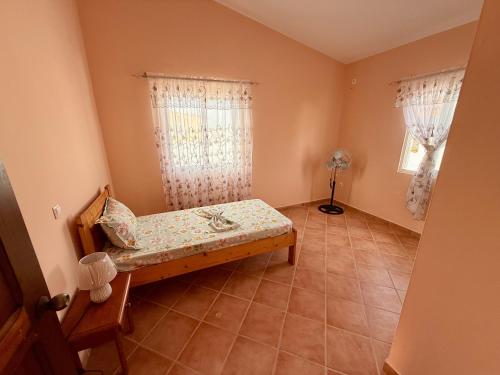 a bedroom with a bed in a room with a window at Ocean Pearl Beach House in Morro