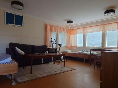a living room with a couch and a table at Höghedens camping in Älvsbyn
