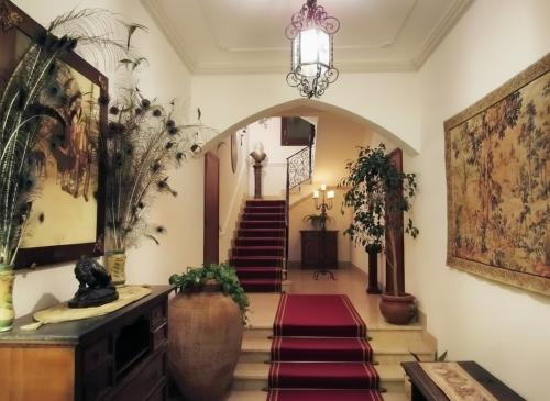 a hallway with stairs and a chandelier at Candalù - Villa Giardinata in Valderice