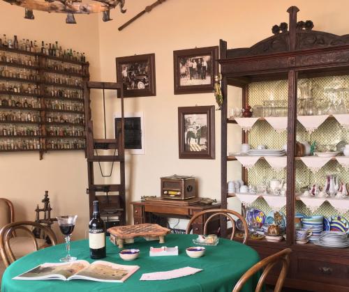 a dining room with a table with a green table cloth at Candalù - Villa Giardinata in Valderice