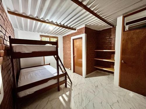 a room with two bunk beds and a door at Villa Arcoíris in Paita