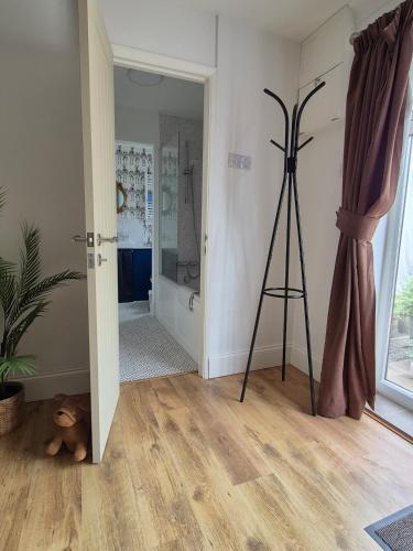 a bathroom with a tripod in a room with a shower at Highlands in Pinchbeck