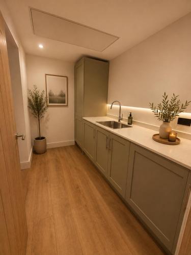 a kitchen with a sink and a counter top at Blackberry Barn in Baltonsborough
