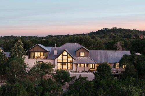 an aerial view of a home with a metal roof at Sunset Ridge Ranch - Pool Outdoor Kitchen & Views in Dripping Springs