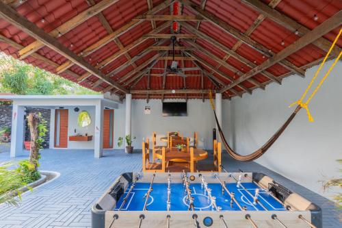 a house with a pool and a table and a boat at "Hotel Relax" in Las Pozas
