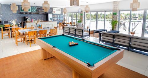 a pool table in the middle of a room at Mia Reef Isla Mujeres - All Inclusive Resort in Isla Mujeres