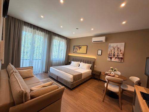a hotel room with a bed and a couch at Brianza Home in Giussano