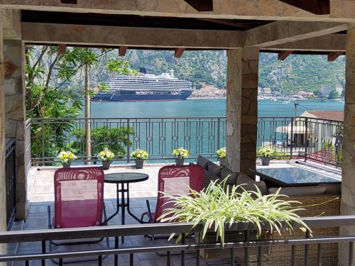 a balcony with a cruise ship in the water at Holiday house in Kotor