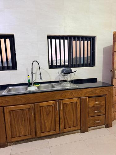 a kitchen with a sink and a counter top at Oikos Residencial in Chimoio